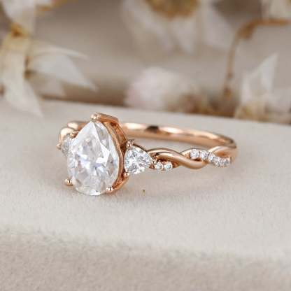 1.5 Carat Pear Shape Moissanite Twist Engagement Ring In 14K Rose Gold