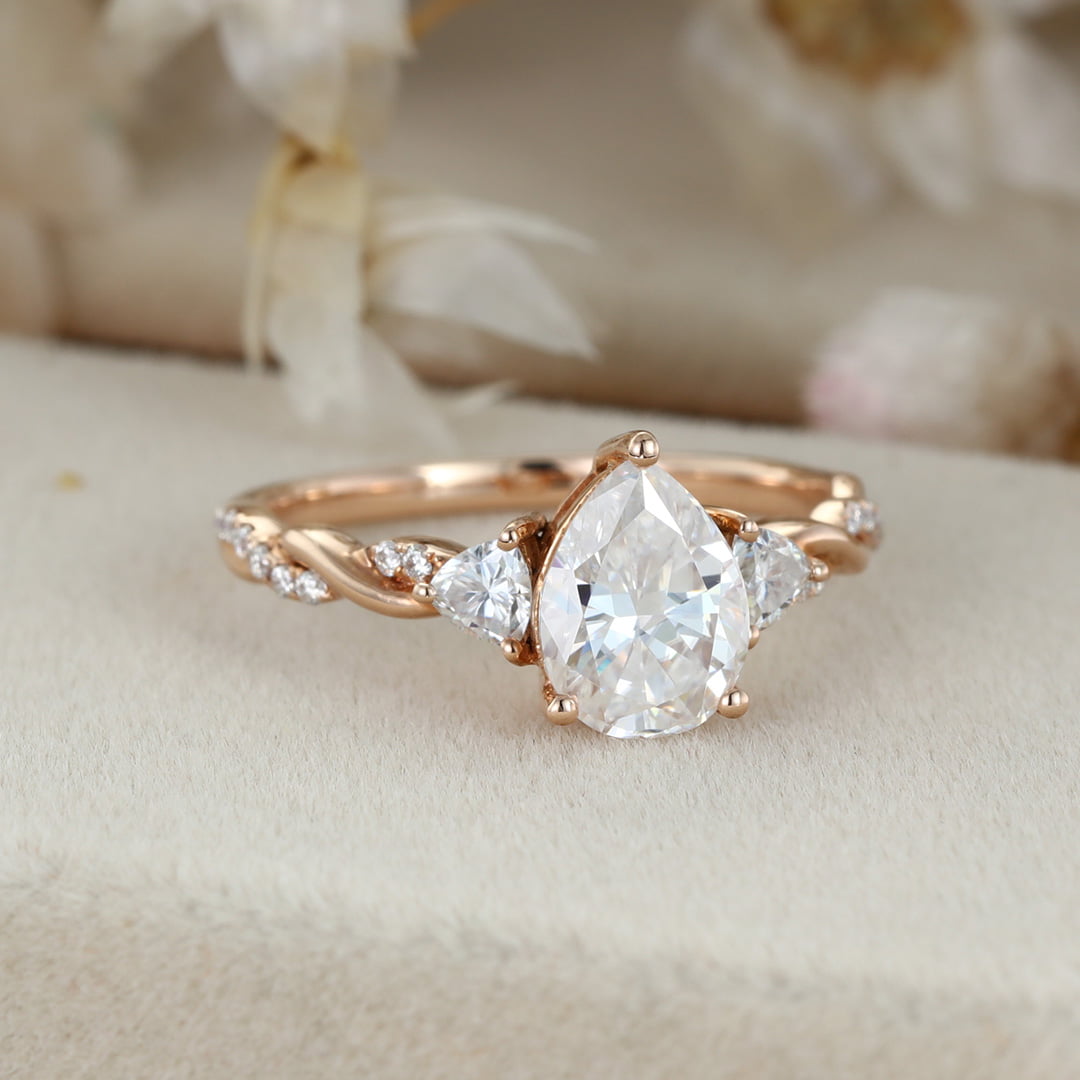1.5 Carat Pear Shape Moissanite Twist Engagement Ring In 14K Rose Gold