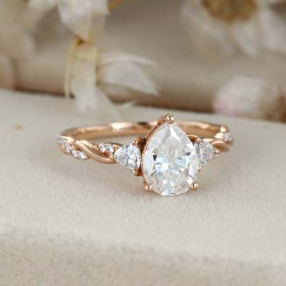 1.5 Carat Pear Shape Moissanite Twist Engagement Ring In 14K Rose Gold