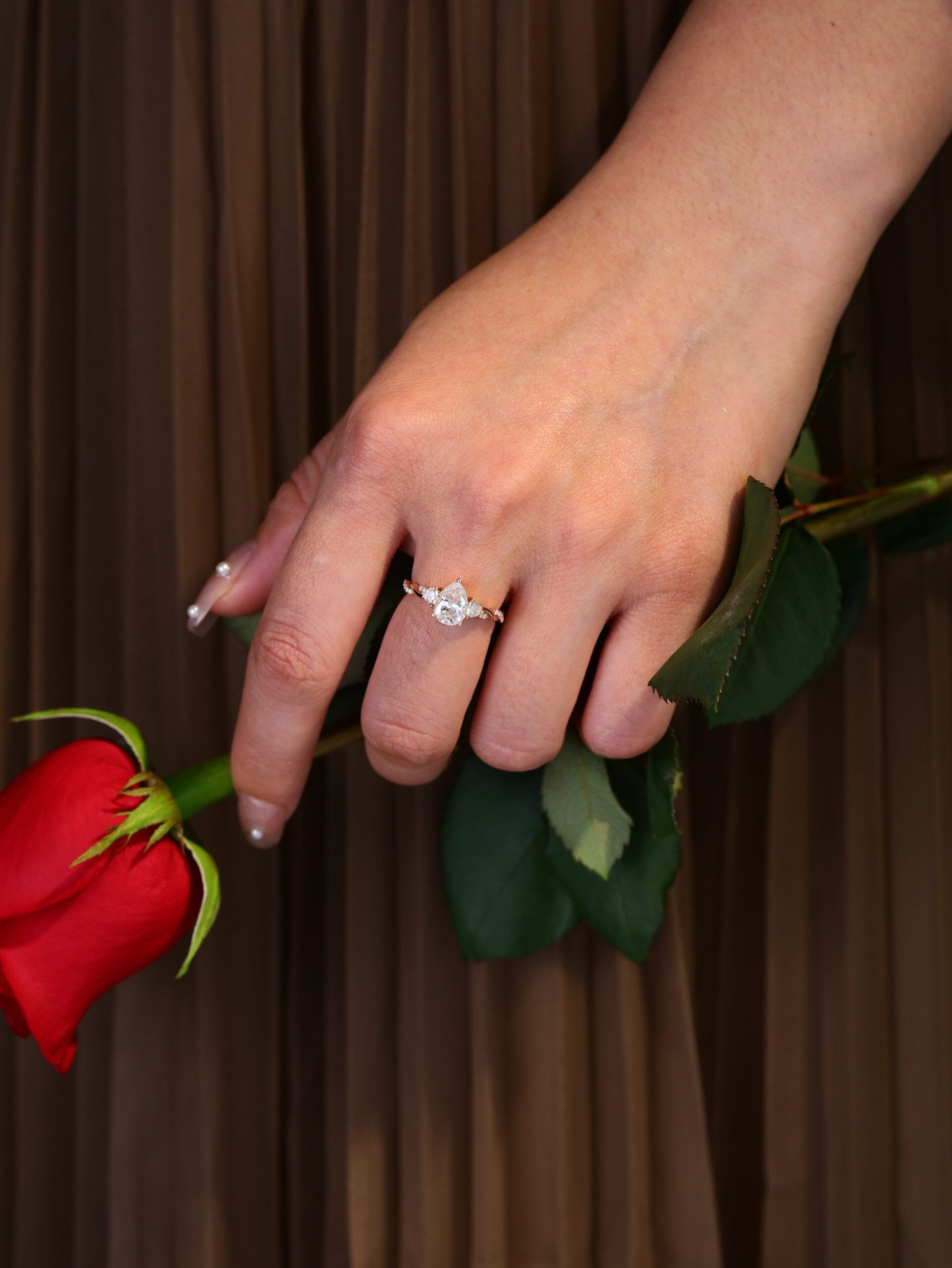 1.5 Carat Pear Shape Moissanite Twist Engagement Ring In 14K Rose Gold