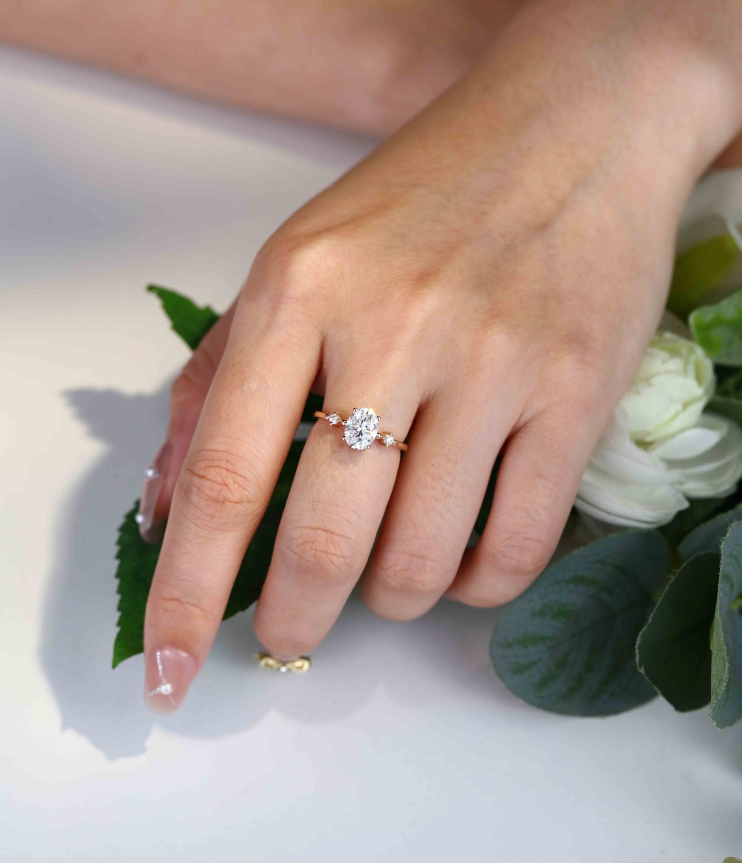 1.5 Carat Oval Moissanite Three Stone Engagement Ring In 10K Rose Gold