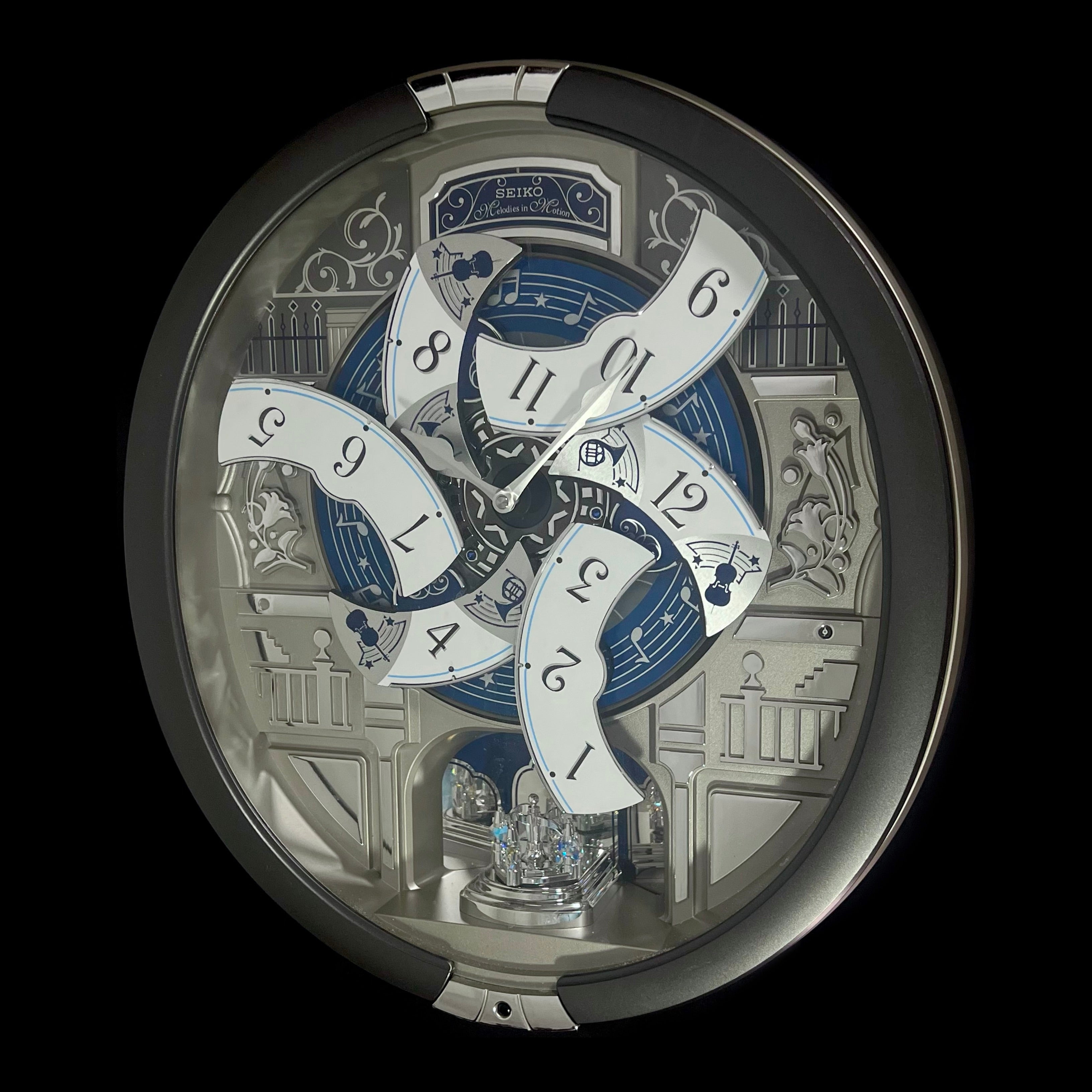 “Musical Motifs” Melodies in Motion Dancing Dial Musical Wall Clock