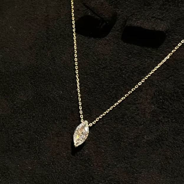 Brilliant marquise cut simulated diamond pendant on a delicate platinum chain against black background