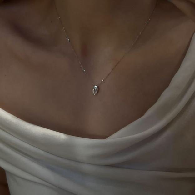 Model wearing an elegant platinum plated marquise cut diamond pendant necklace