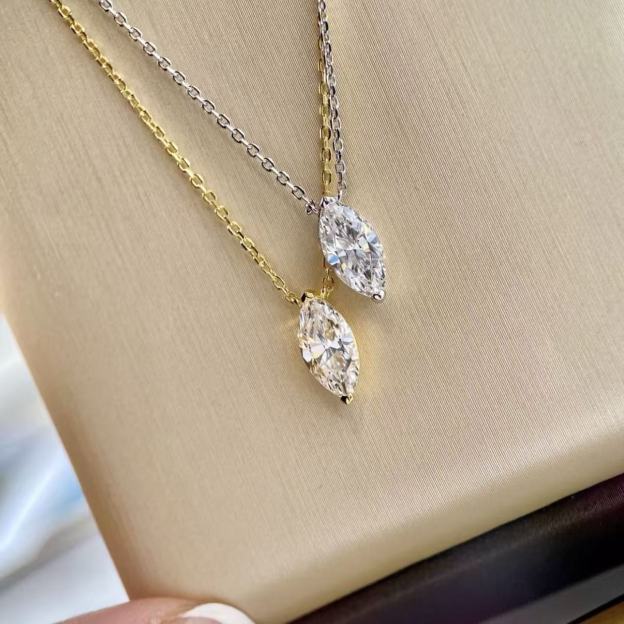 18k gold and platinum plated silver marquise cut necklaces side by side