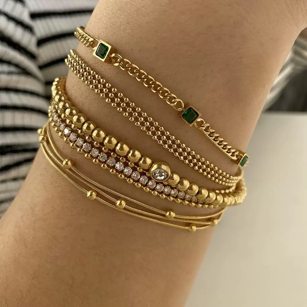Gold-plated bracelet, emerald gemstones, women's jewelry, fashion accessory, luxury bracelet