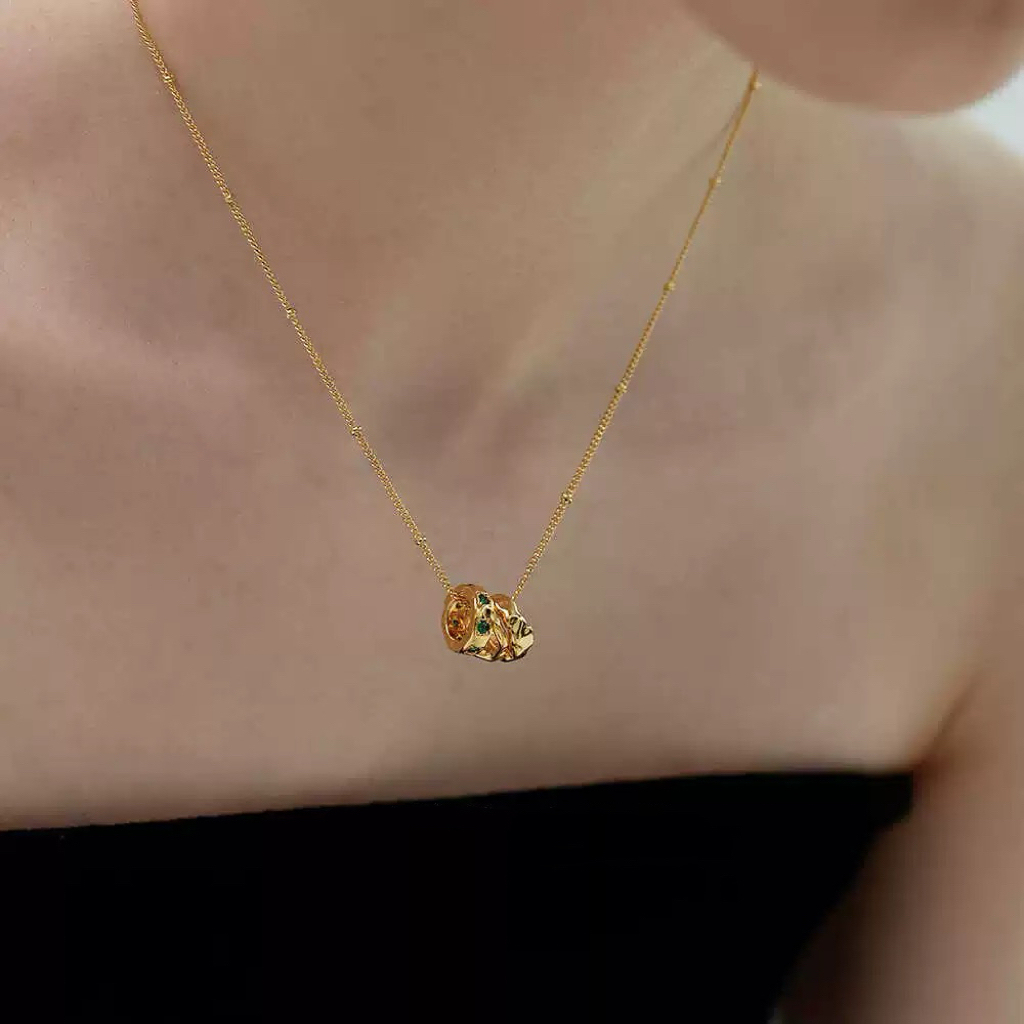 Gold-tone necklace with three emerald gemstones