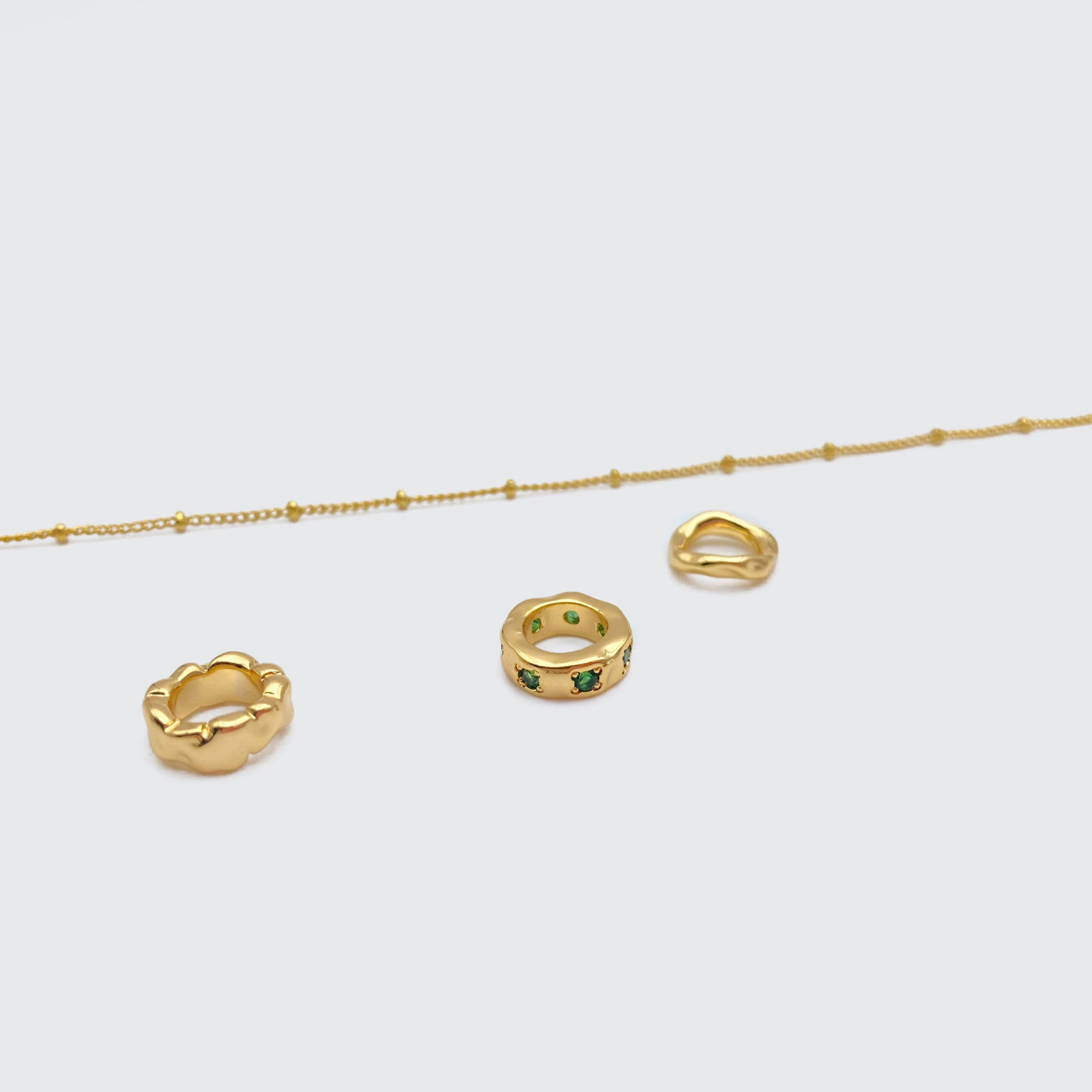 Gold-tone necklace with three emerald gemstones