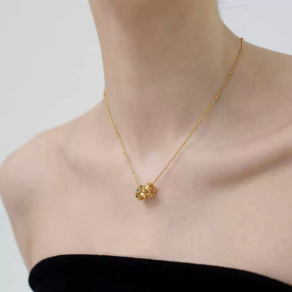 Gold-tone necklace with three emerald gemstones