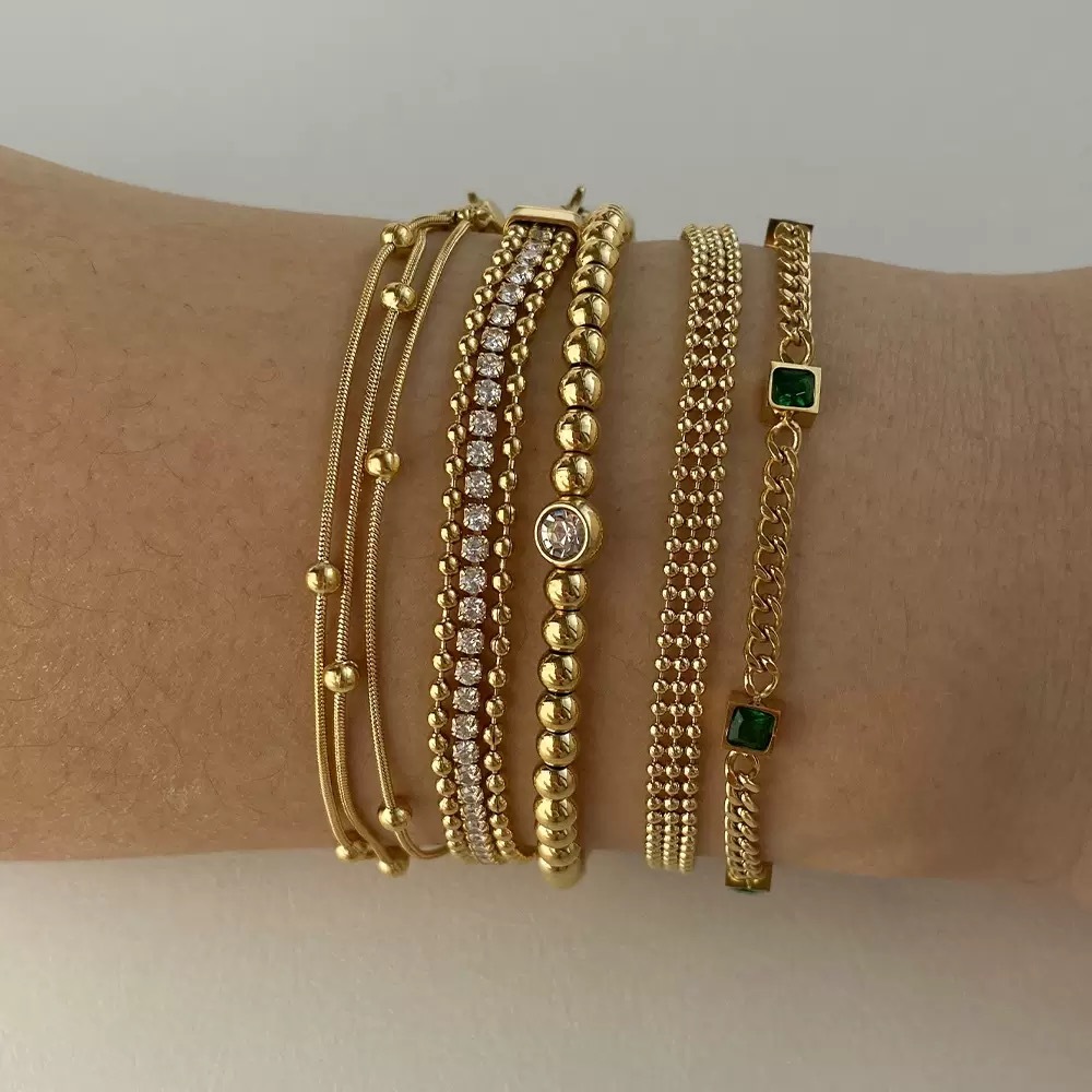 Gold-plated bracelet, emerald gemstones, women's jewelry, fashion accessory, luxury bracelet