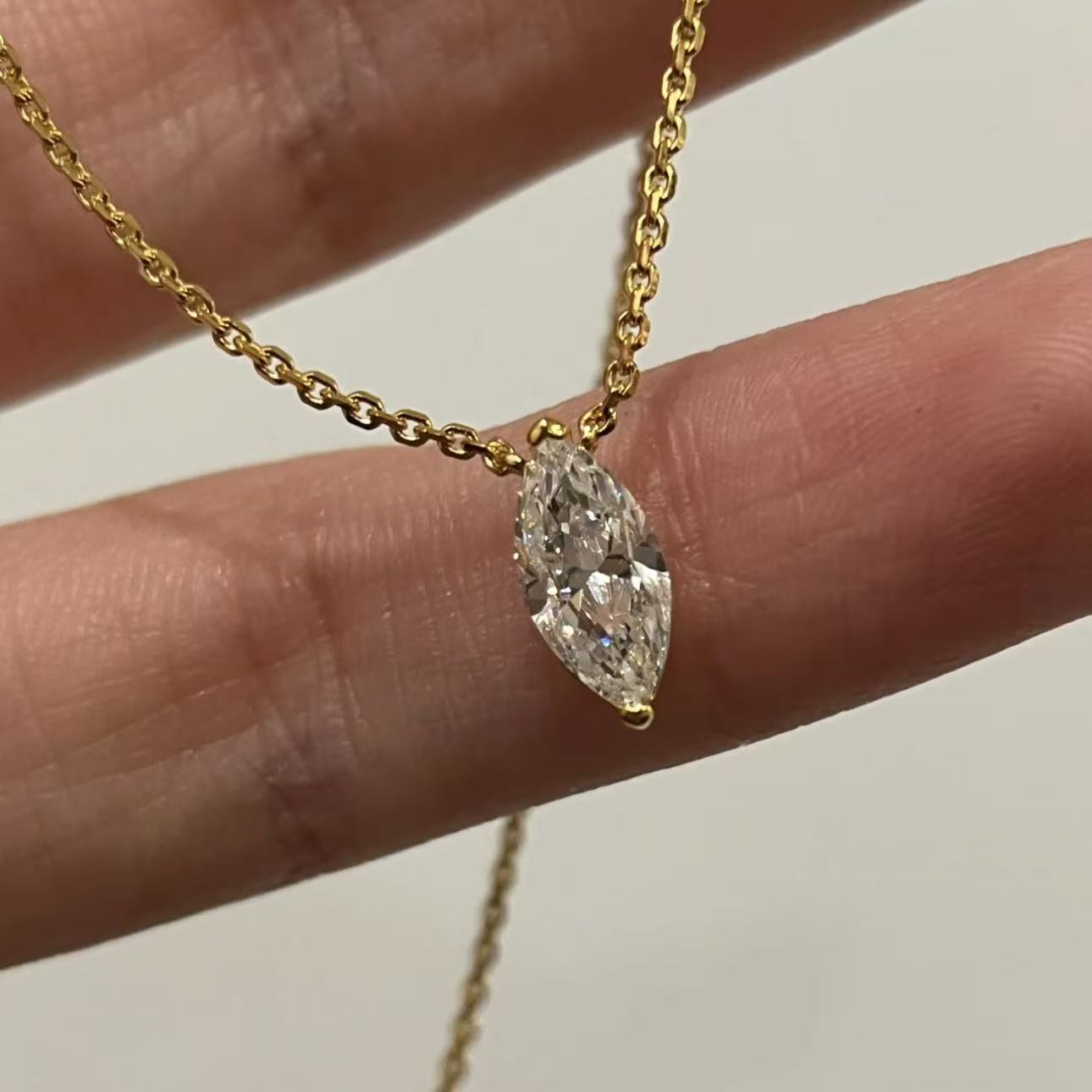 Close-up of a 1-carat premium simulated marquise diamond pendant in 18k gold