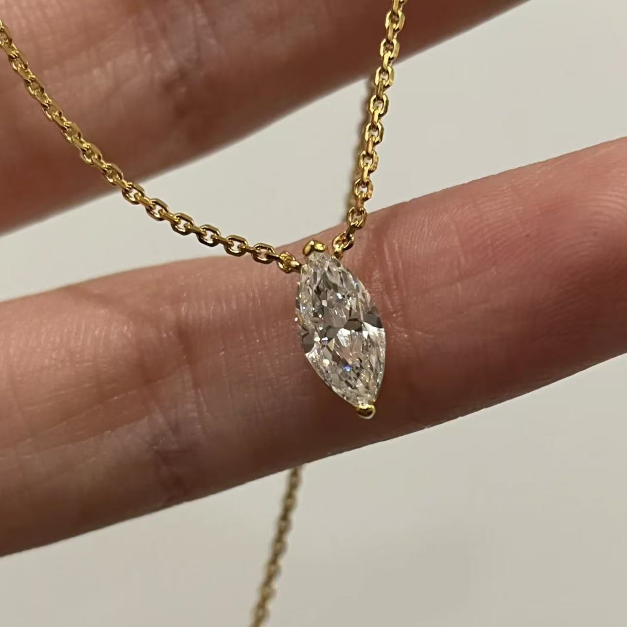 Close-up of a 1-carat premium simulated marquise diamond pendant in 18k gold