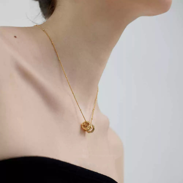 Gold-tone necklace with three emerald gemstones