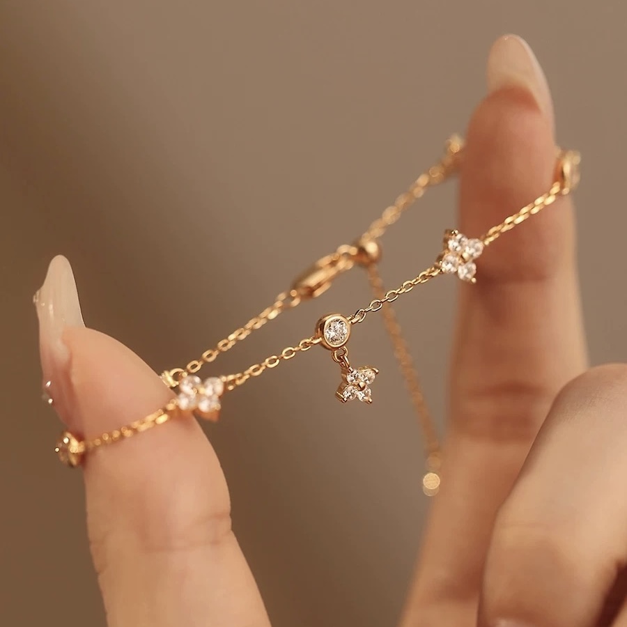 Gold and silver bracelet with clover charms