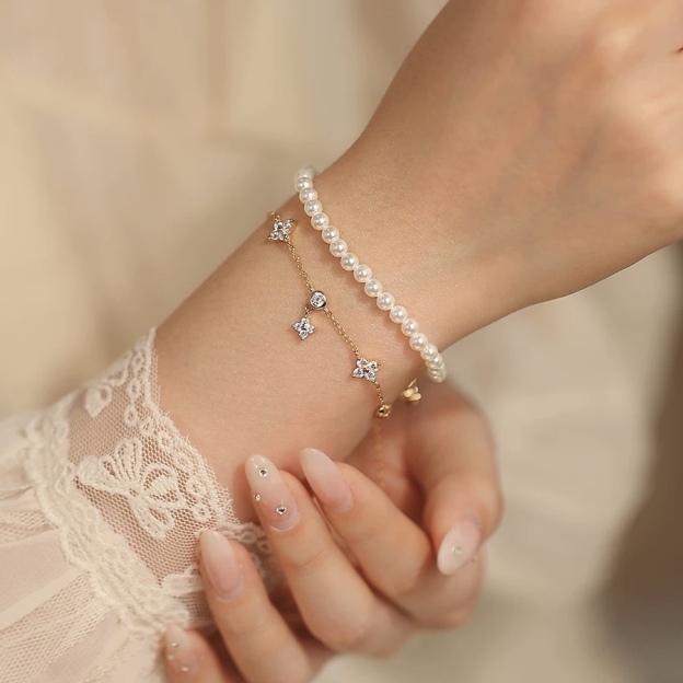 Gold and silver bracelet with clover charms