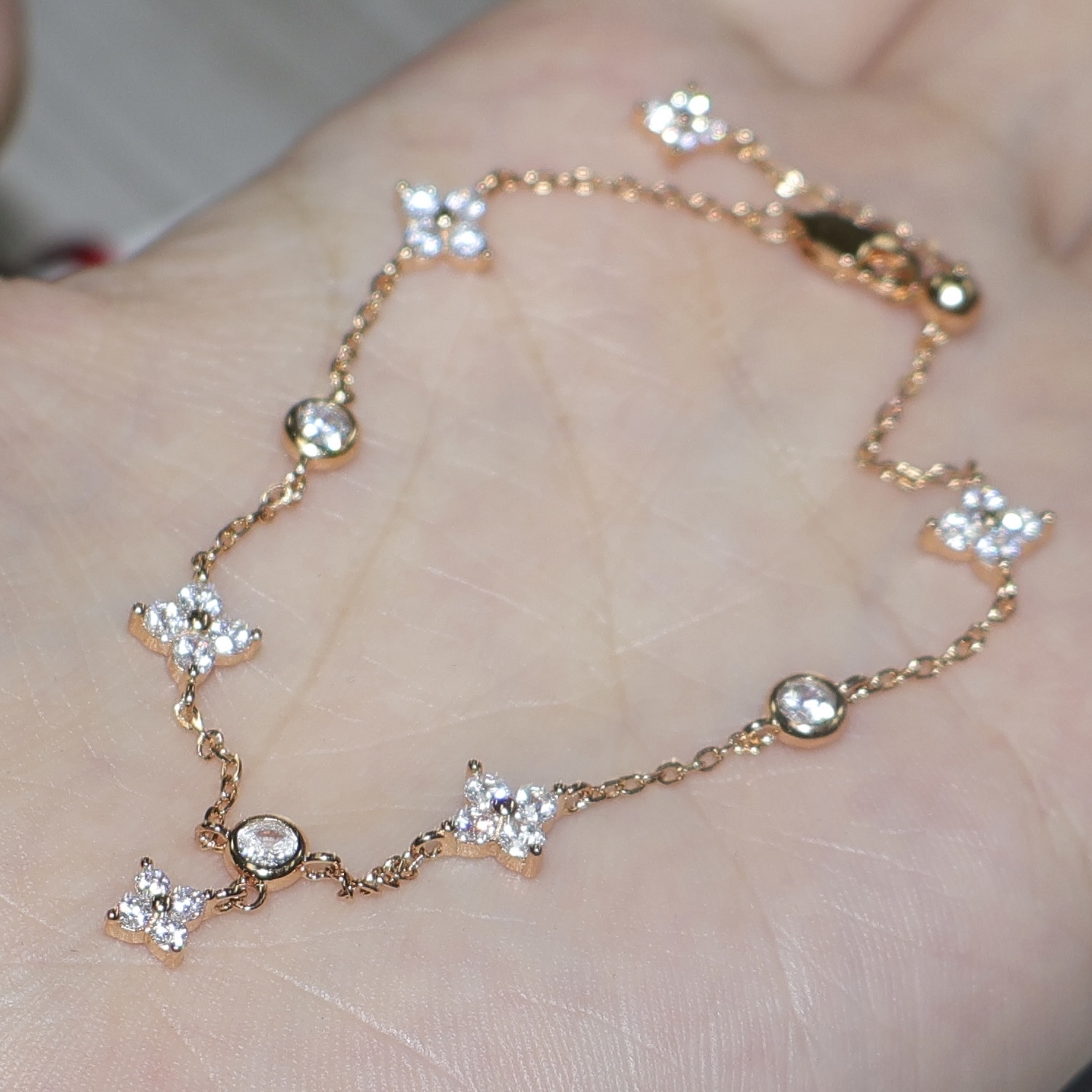 Gold and silver bracelet with clover charms
