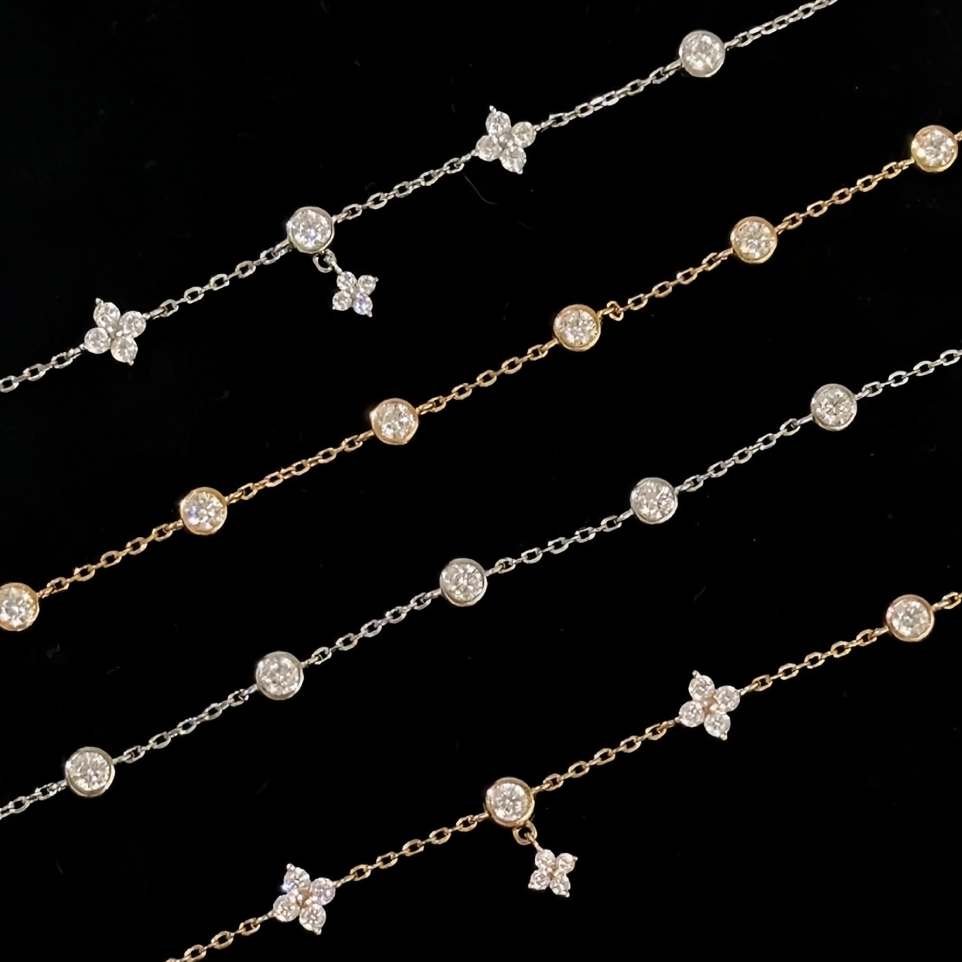 Gold and silver bracelet with clover charms