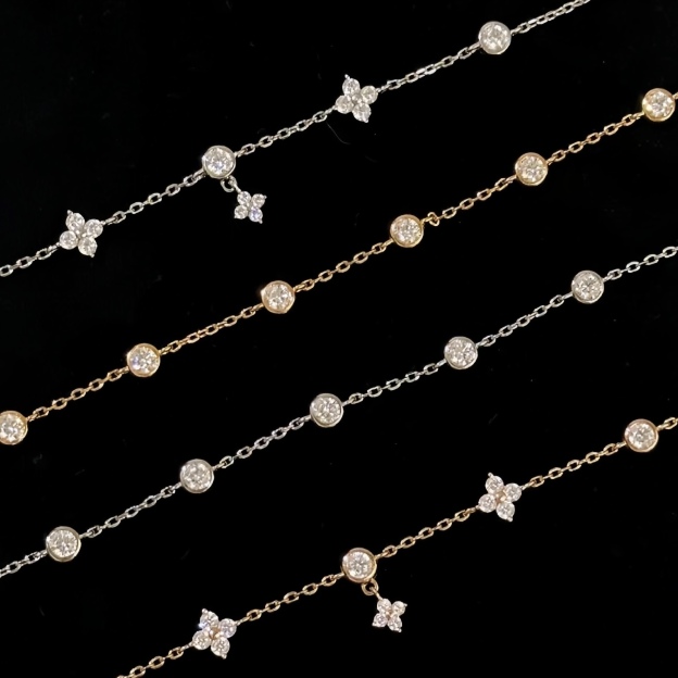 Gold and silver bracelet with clover charms