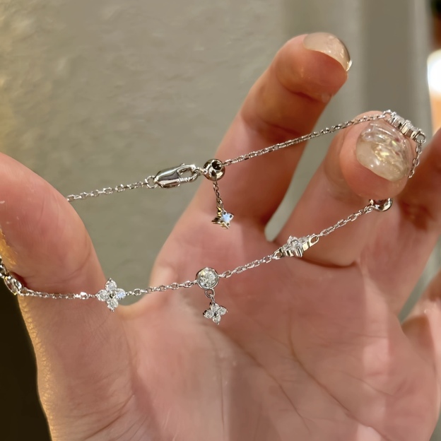 Gold and silver bracelet with clover charms