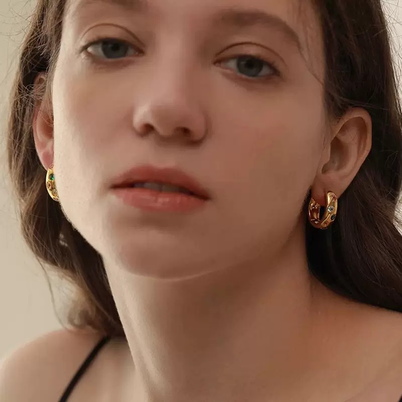 Gold and silver hoop earrings with colorful gemstones