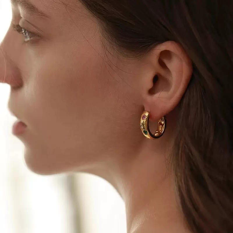 Gold and silver hoop earrings with colorful gemstones