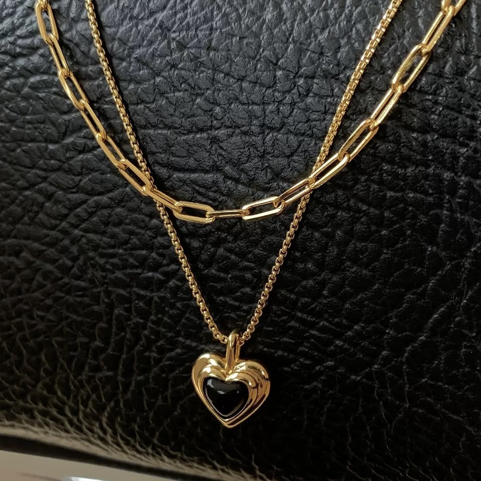Gold-tone necklace with black heart pendant
