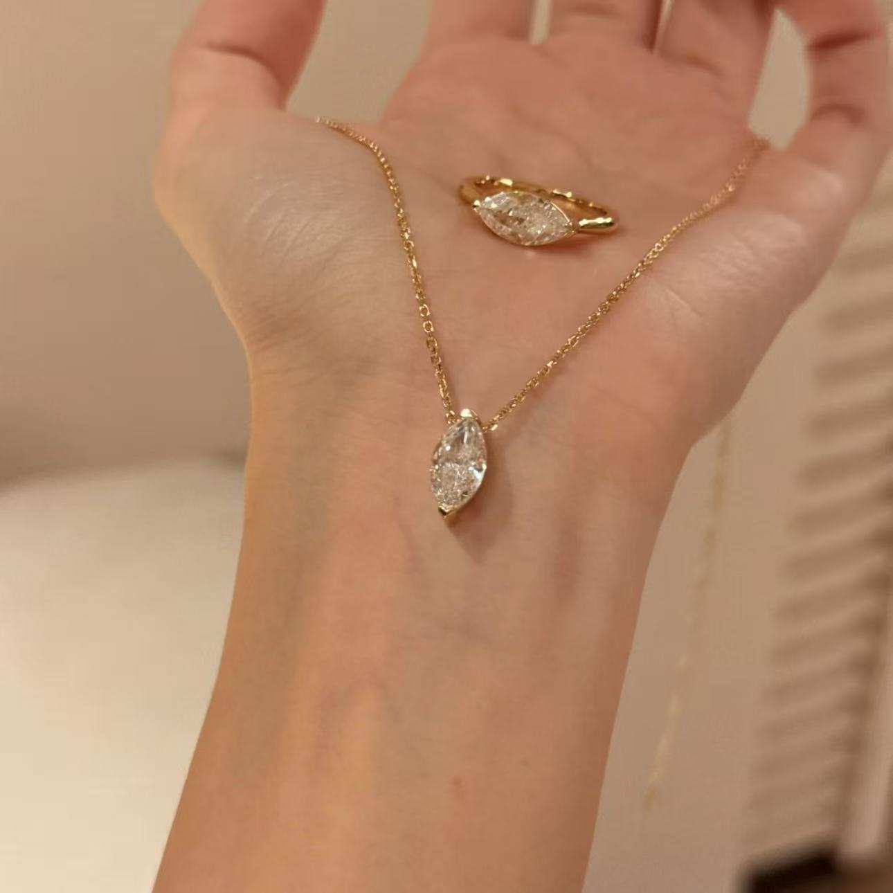 18k gold plated marquise cut simulated diamond necklace and matching ring on hand