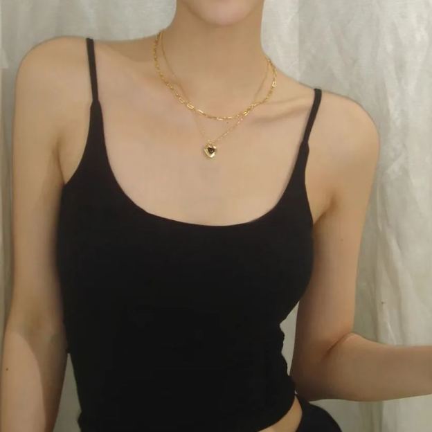 Gold-tone necklace with black heart pendant