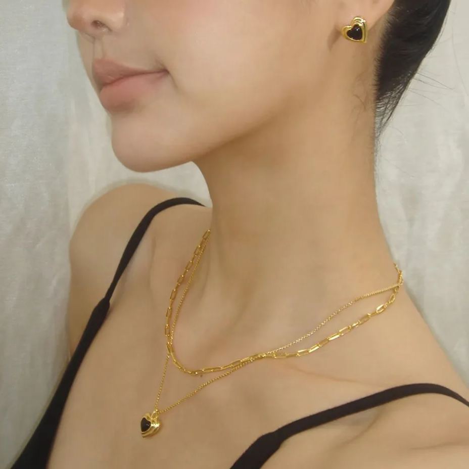 Gold-tone necklace with black heart pendant