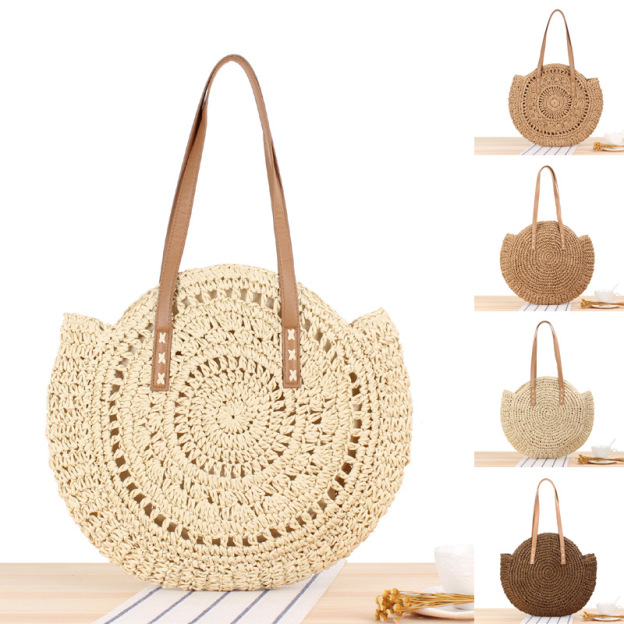 Handwoven round straw beach shoulder bag with comfortable straps, displayed against a neutral background.