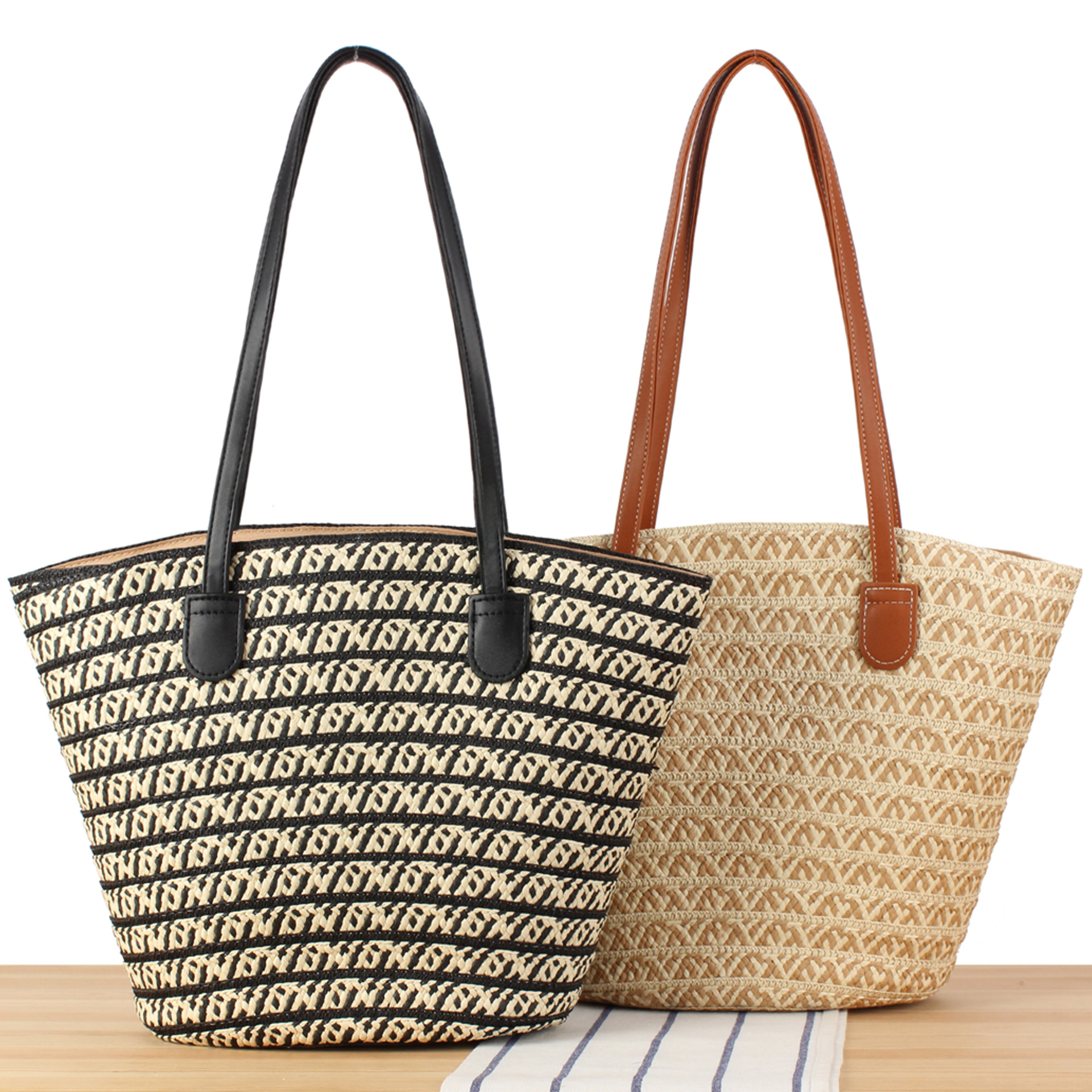 Handwoven straw tote bag with comfortable shoulder straps, displayed against a neutral background.