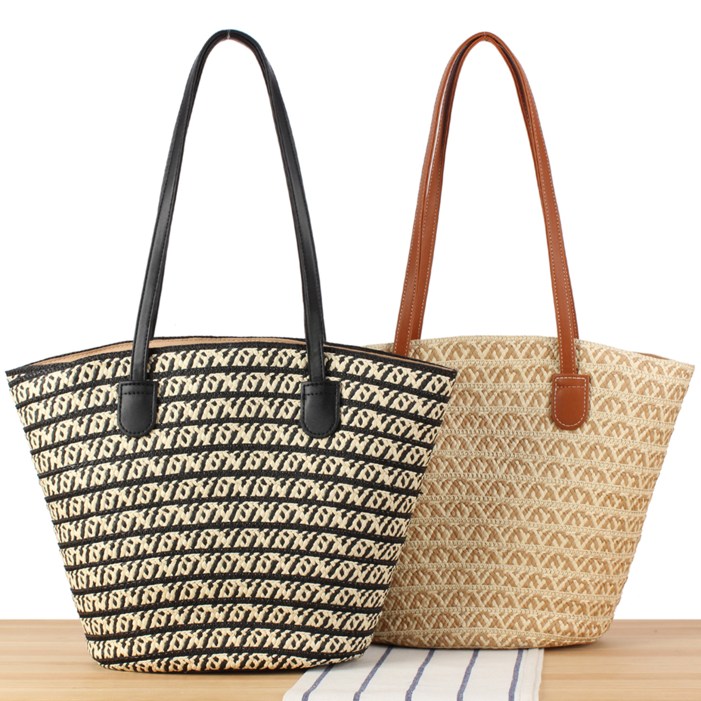 Handwoven straw tote bag with comfortable shoulder straps, displayed against a neutral background.