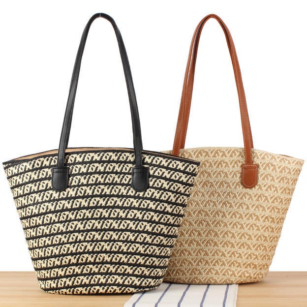 Handwoven straw tote bag with comfortable shoulder straps, displayed against a neutral background.