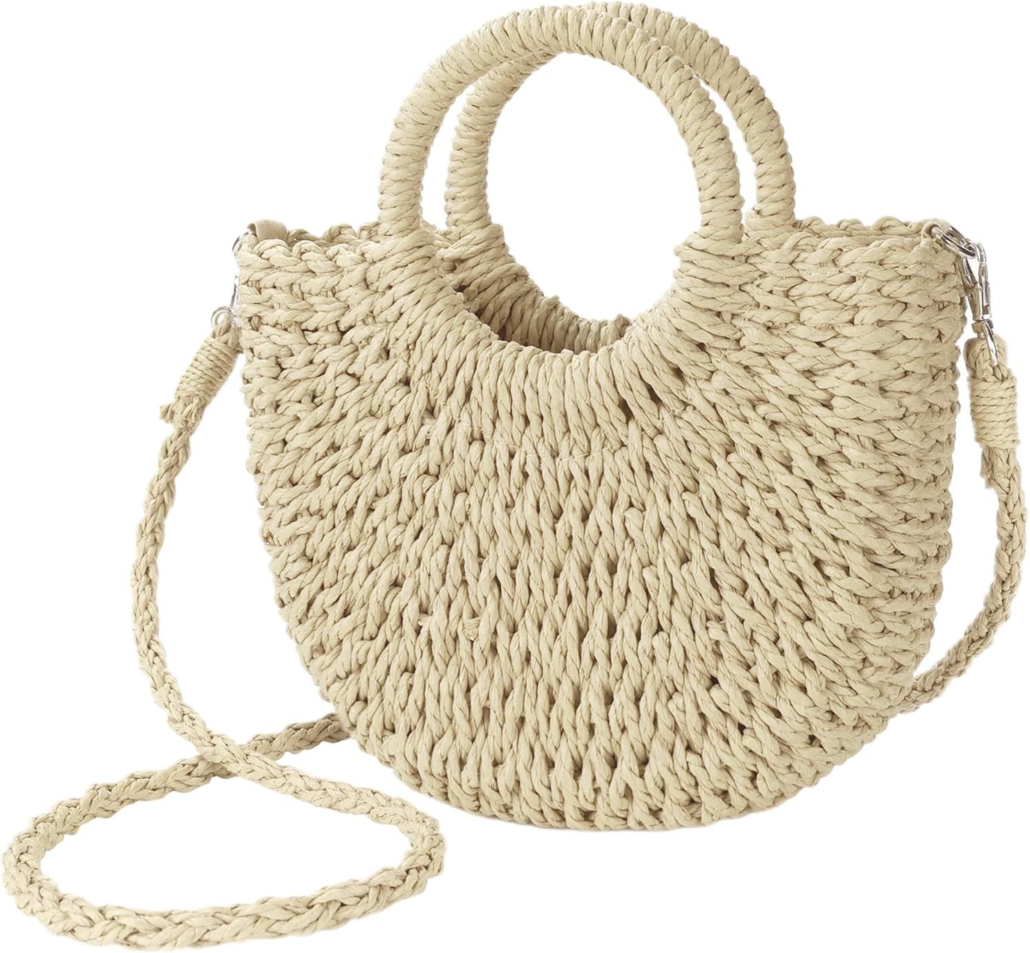 A handwoven straw beach bag with a top handle and detachable crossbody strap is displayed against a neutral background.