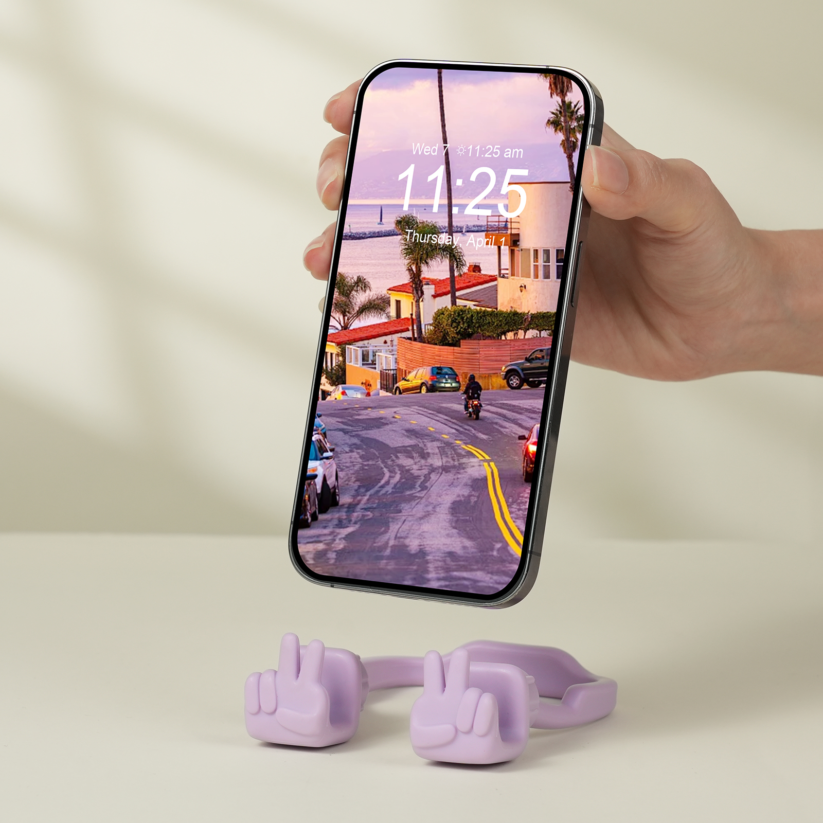 {"default":"Purple Yeah Vibe expressive phone stand supporting a smartphone above a white table, showcasing the celebration gesture."}

