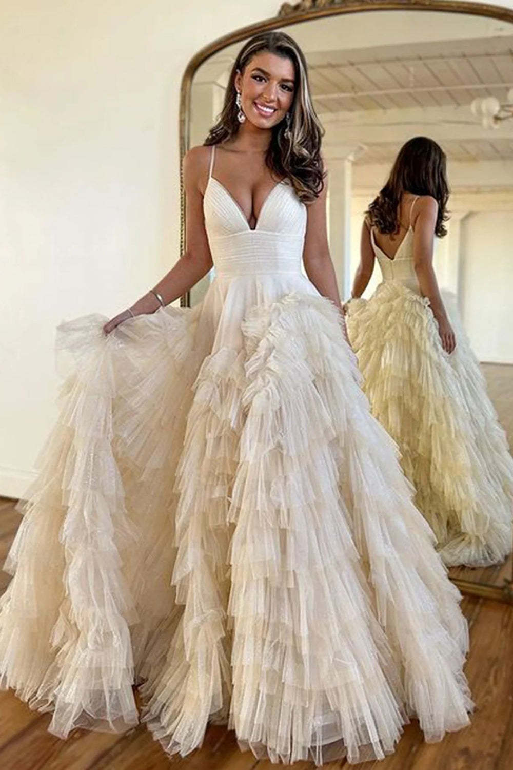 Pink long prom dress with spaghetti straps and ruffles in A-line style