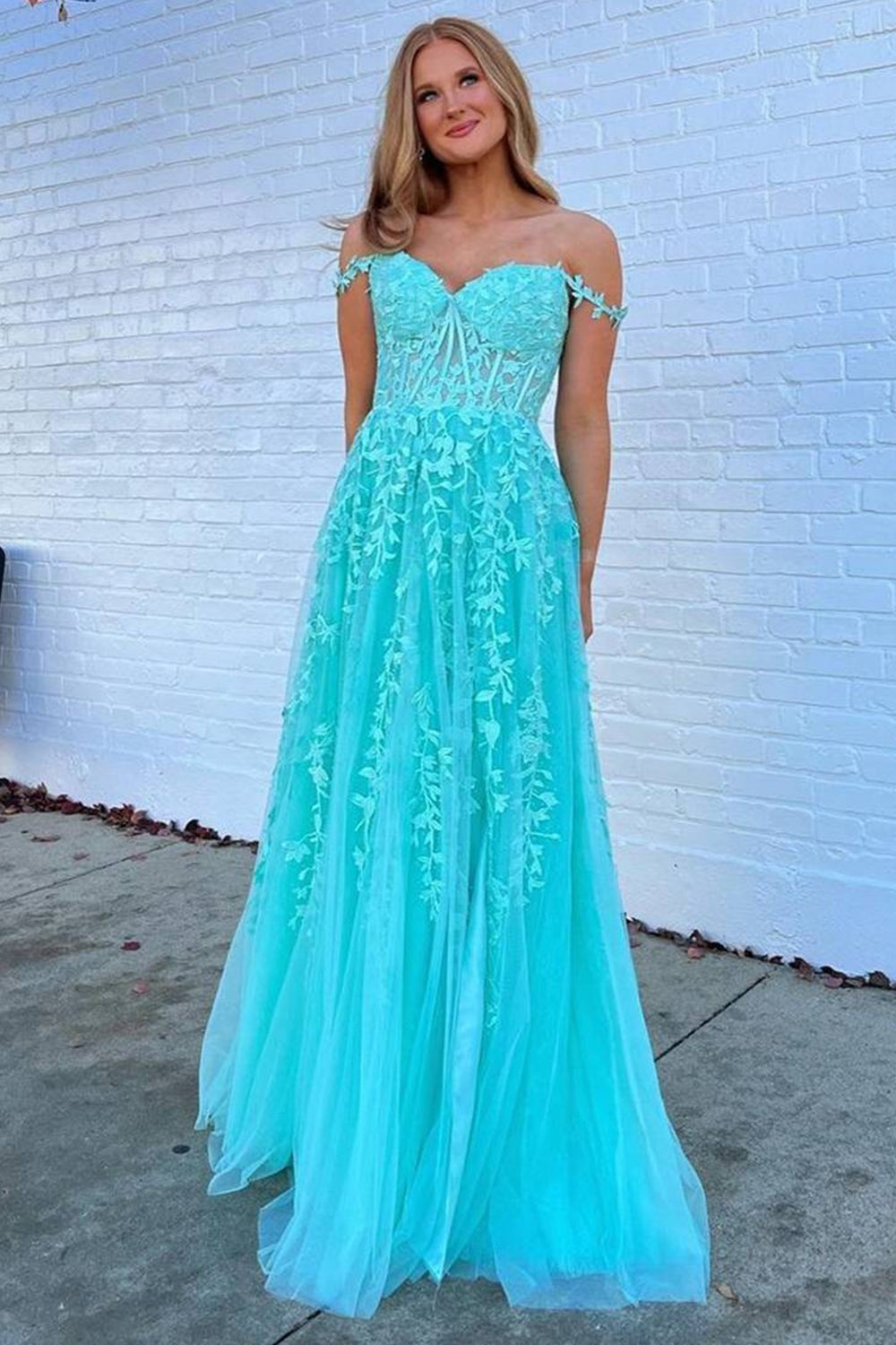 Prom dress in navy featuring off-the-shoulder design and appliques