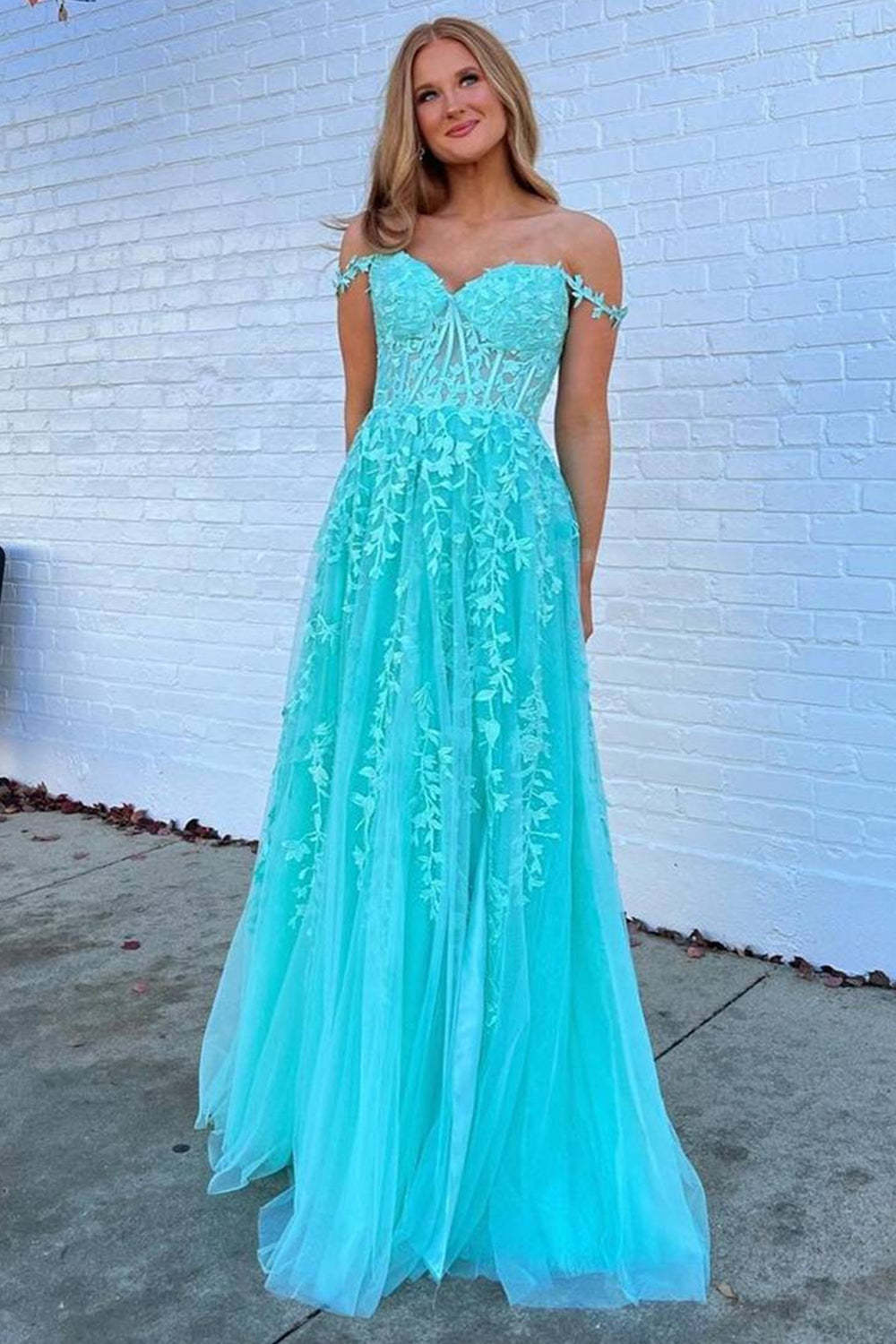 Prom dress in navy featuring off-the-shoulder design and appliques