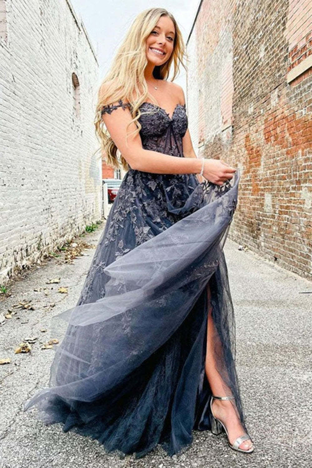 Prom dress in navy featuring off-the-shoulder design and appliques