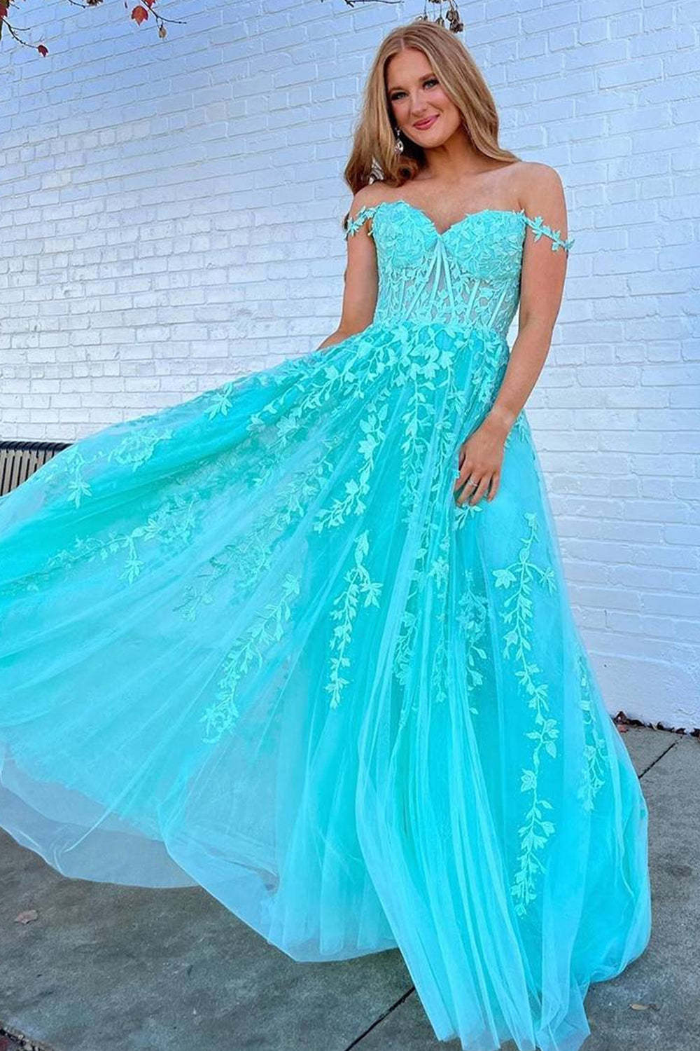 Prom dress in navy featuring off-the-shoulder design and appliques