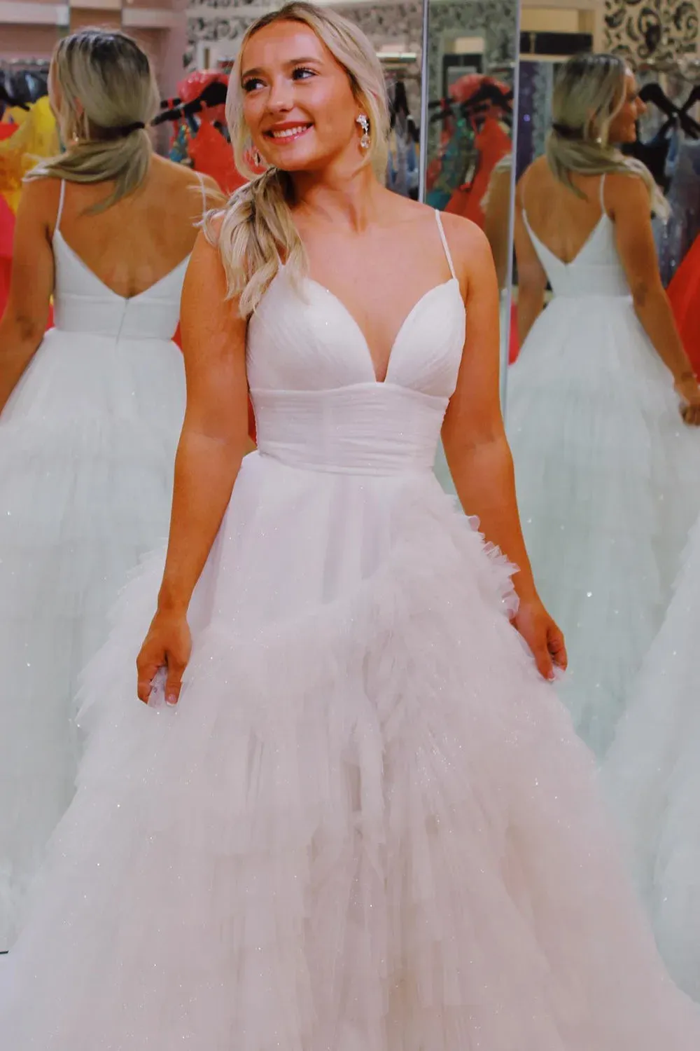 Pink long prom dress with spaghetti straps and ruffles in A-line style