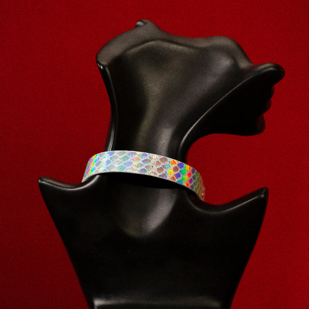 chicchok breathless choker featuring a white textured design with iridescent scales that reflect vibrant rainbow colors