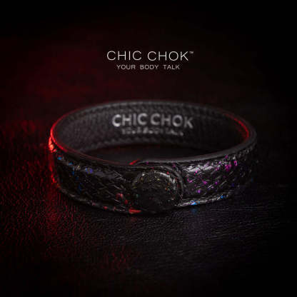 Nebula Doll Bracelet Luxurious black leather bracelet with textured scales, adorned with shimmering multicolor glitter accents, inspired by the brilliance of a starry night sky, showcasing elegance and individuality.