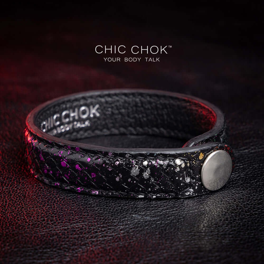 Nebula Doll Bracelet Luxurious black leather bracelet with textured scales, adorned with shimmering multicolor glitter accents, inspired by the brilliance of a starry night sky, showcasing elegance and individuality.