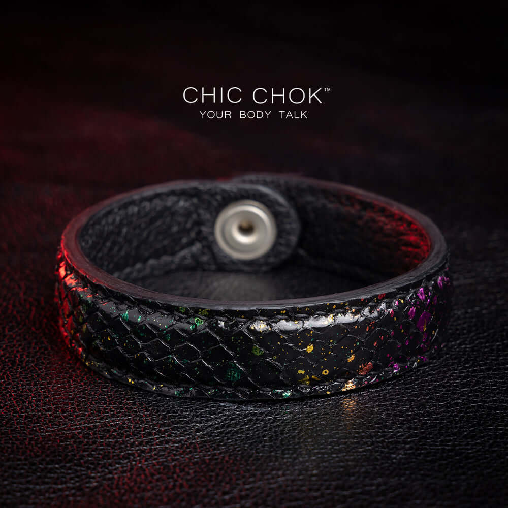 Nebula Doll Bracelet Luxurious black leather bracelet with textured scales, adorned with shimmering multicolor glitter accents, inspired by the brilliance of a starry night sky, showcasing elegance and individuality.