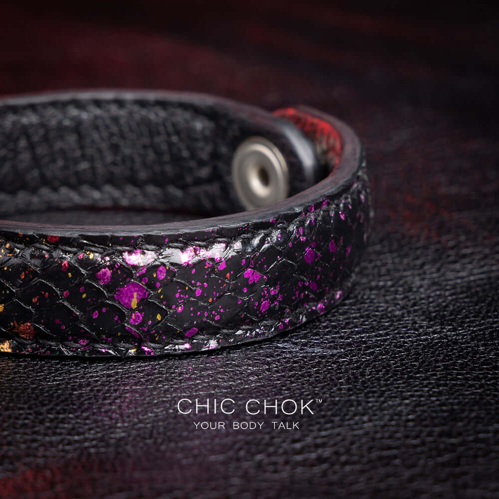 {"default":"Nebula Doll Bracelet Luxurious black leather bracelet with textured scales, adorned with shimmering multicolor glitter accents, inspired by the brilliance of a starry night sky, showcasing elegance and individuality."}
