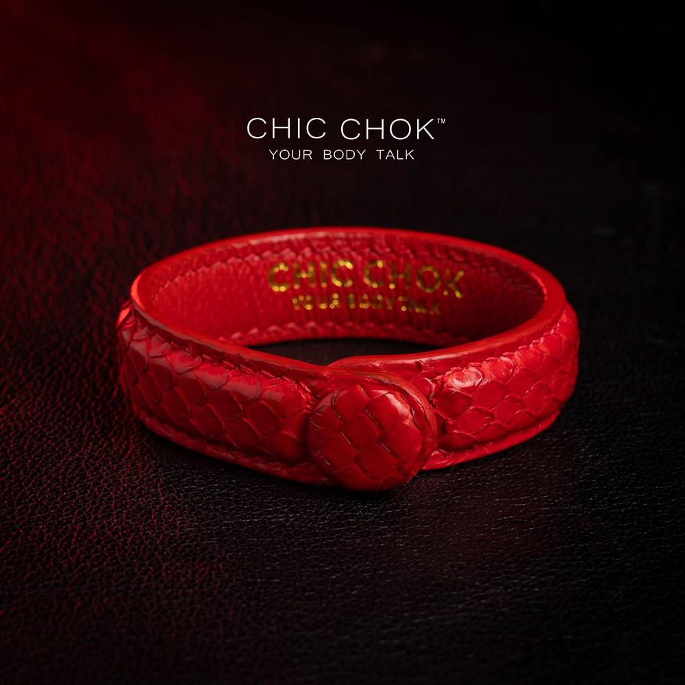 chicchok red scaled leather bracelet featuring a bold circular clasp and luxurious gold branding, designed to inspire confidence and elevate any outfit
