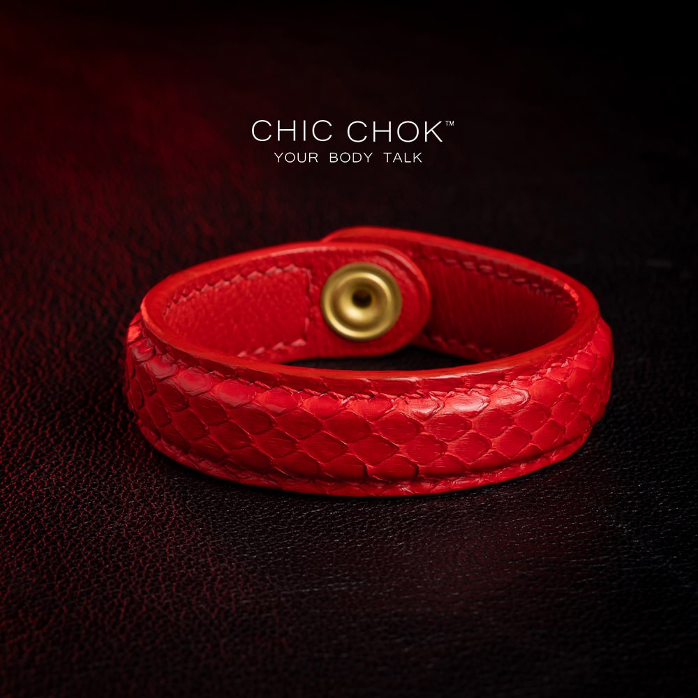 chicchok red scaled leather bracelet featuring a bold circular clasp and luxurious gold branding, designed to inspire confidence and elevate any outfit