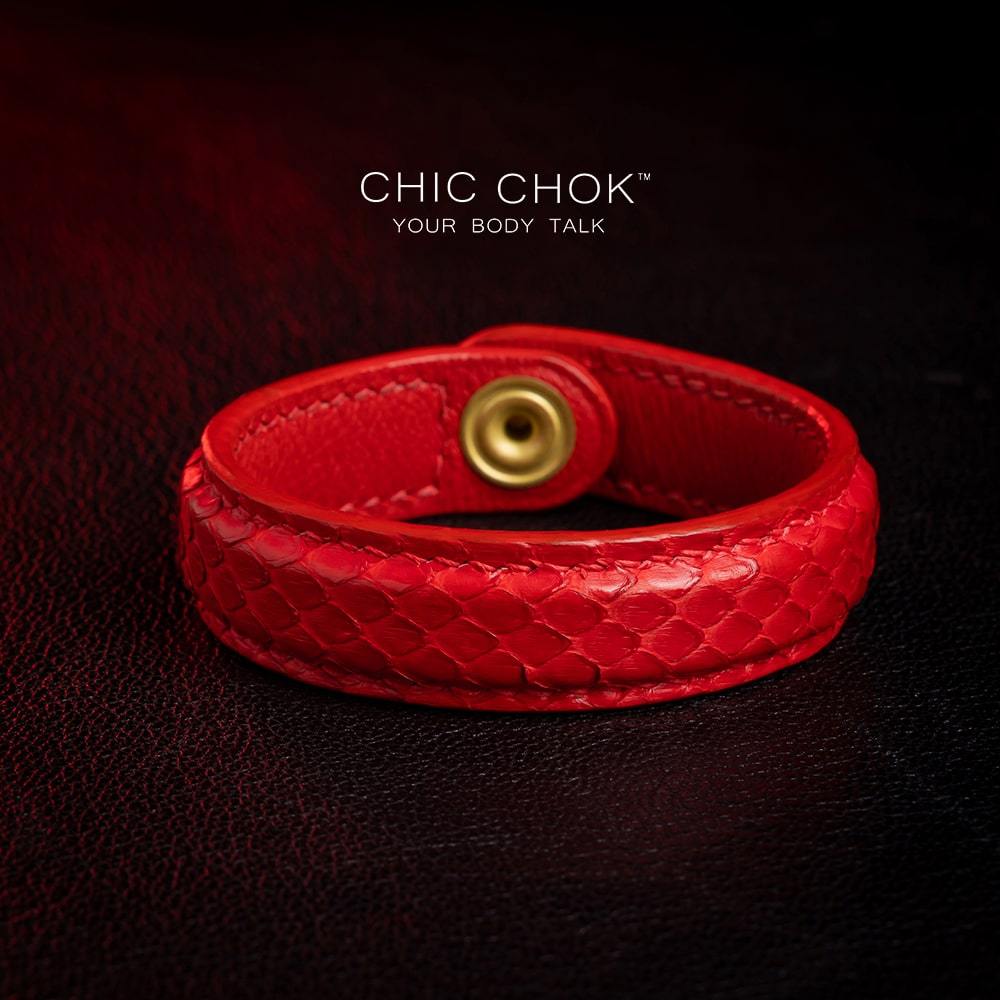 chicchok red scaled leather bracelet featuring a bold circular clasp and luxurious gold branding, designed to inspire confidence and elevate any outfit