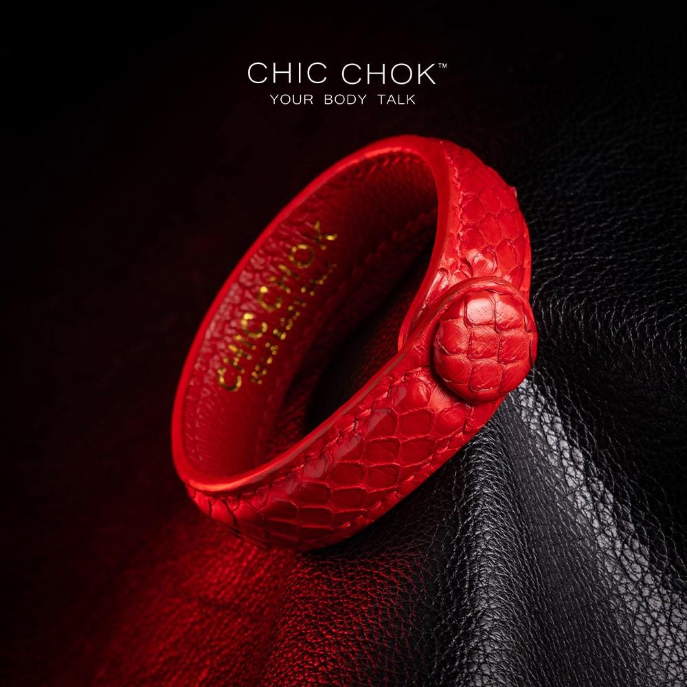 chicchok red scaled leather bracelet featuring a bold circular clasp and luxurious gold branding, designed to inspire confidence and elevate any outfit